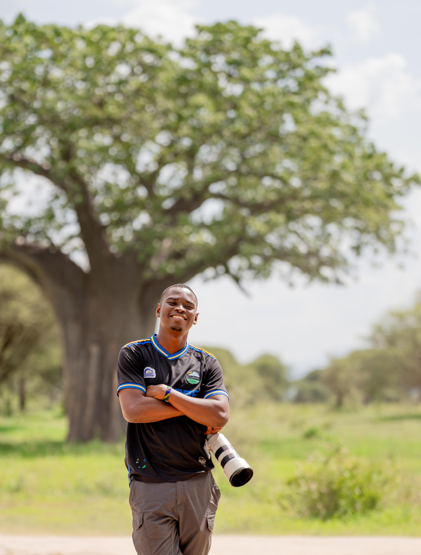 Clement Mabula, founder of Wild Iris Africa, with his camera beneath a baobab